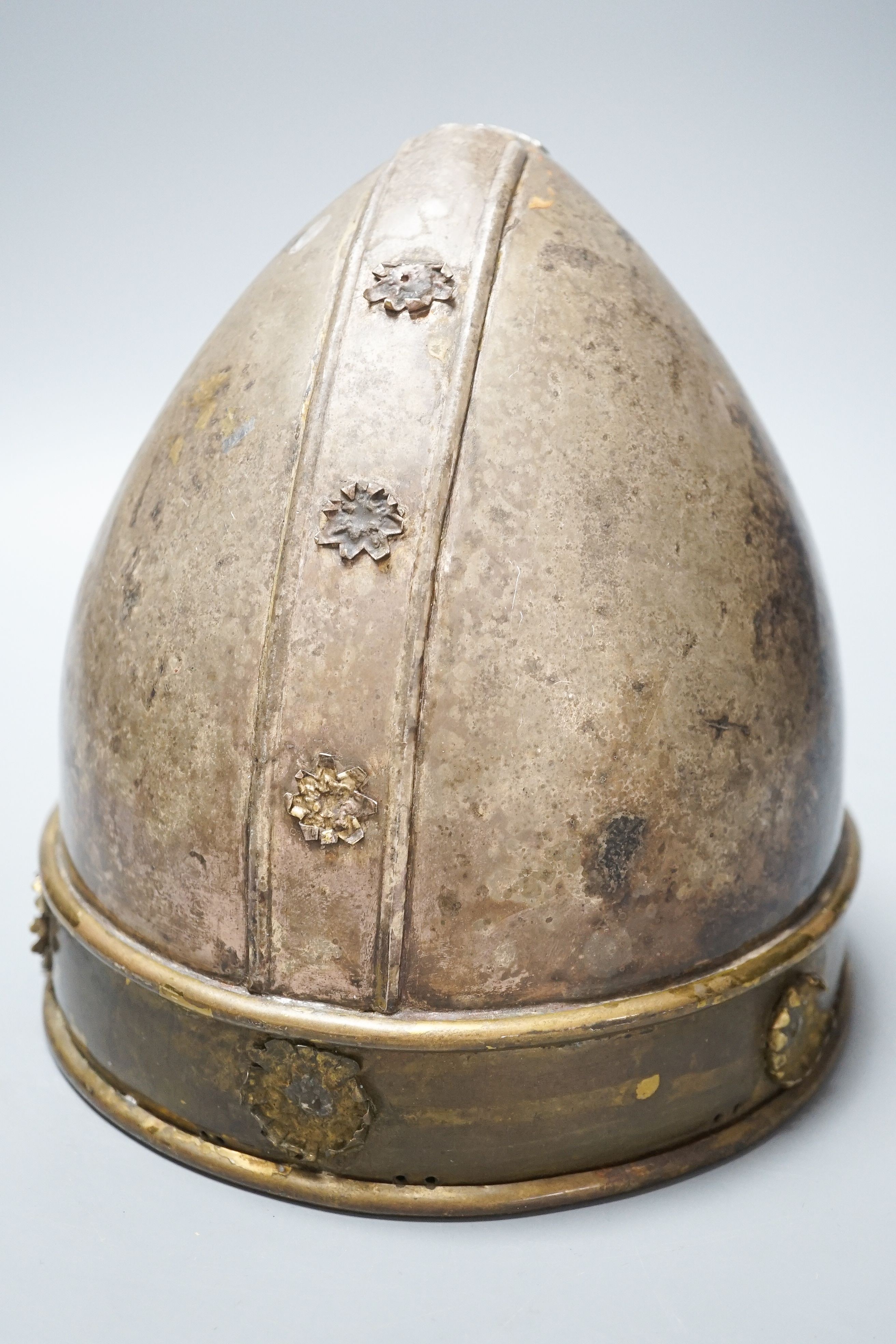 A Middle-Eastern silvered metal and brass helmet and a dagger in sheath